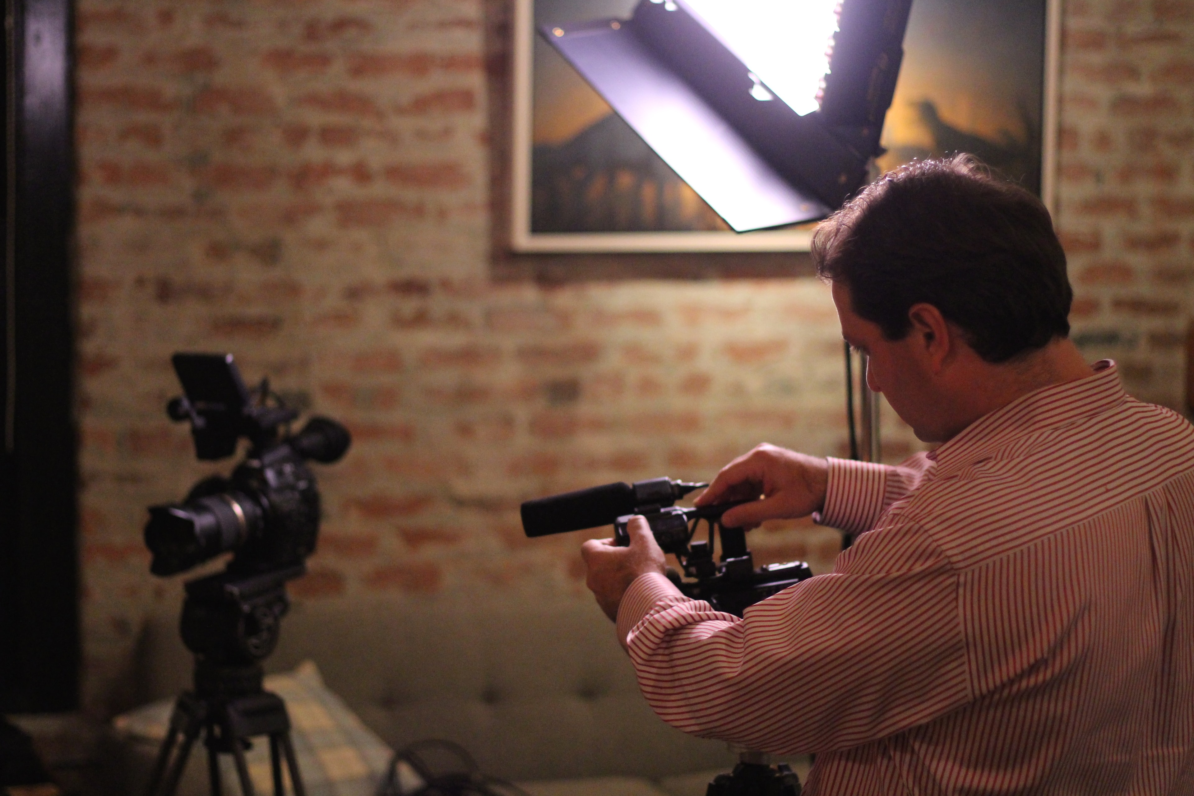 BTS cameraman brick wall studio